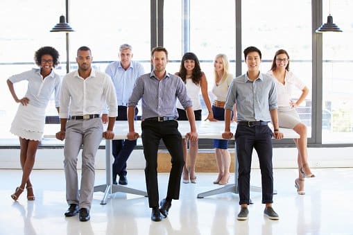 Coworkers posing to camera in meeting room