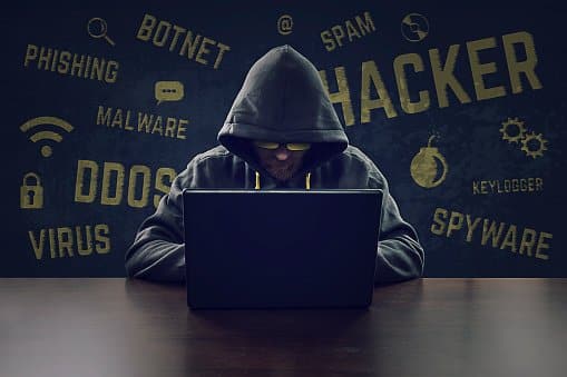 Cyber criminal stealing secrets with laptop