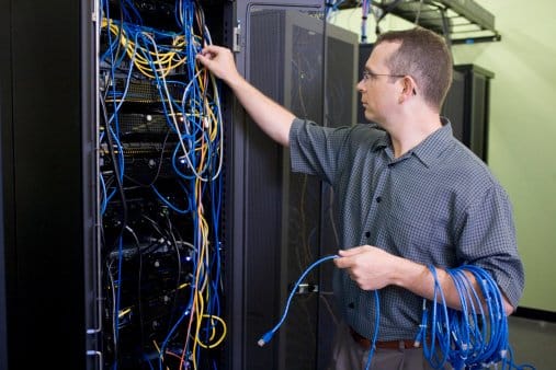 Technician repairing network server cables