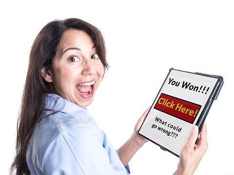 Young Woman Reacts Happily to Winning Prize on her Tablet.