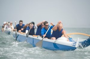 Outrigger canoeing team on water