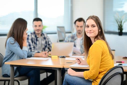 Woman smiling in Tech Solutions meeting